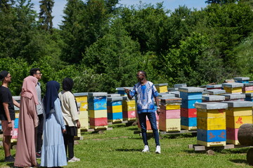 people group visiting local honey production farm