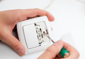 young specialist repairing electrical appliances