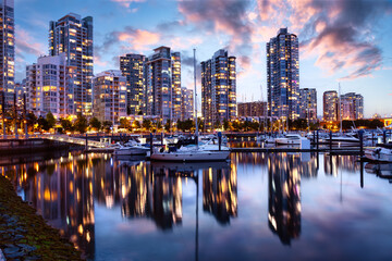 Fototapeta na wymiar False Creek, Vancouver, British Columbia, Canada. Beautiful View of the Marina with boats and a modern Downtown City Buildings. Colorful Sunrise Twilight Sky.