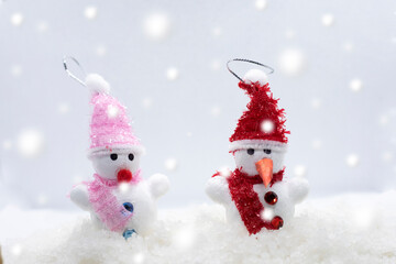 Merry Christmas and happy New Year greeting card with copy-space.Two snowmen standing in winter Christmas landscape.Winter background