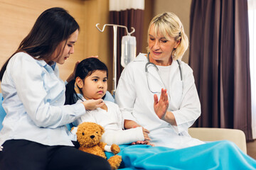 Woman doctor service help support discussing and consulting talk to little girl patient and check up information in hospital