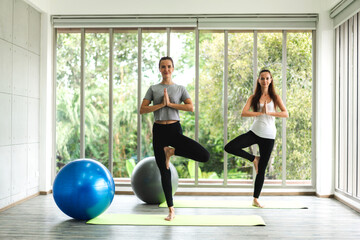 Obraz premium Portrait of sport attractive people woman in sportswear sitting relax and practicing yoga fitness exercise with blue fitball in class training at sport club.Diet concept.Fitness and healthy lifestyle