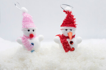Snowmen standing in winter Christmas landscape. New year concept. Winter scene with snow man on white snow background