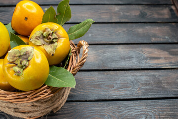 front view fresh persimmons ripe sweet fruits on a wooden desk fruit mellow ripe tree