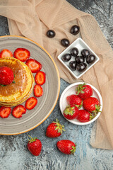 top view delicious pancakes with fresh strawberries on light background sweet cake fruit