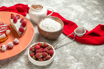 side close view of plate of sweet dessert with chocolate tea sieve berries and red napkin on side on marble background