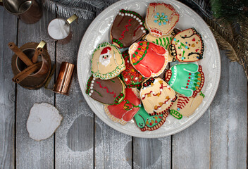 Ugly sweater cookies in a rusting setting on white wooden background, copy space