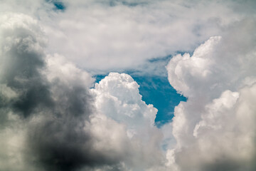 a dramatic white cloud under the background of the blue sky.
