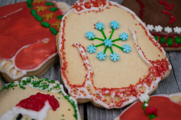 Ugly sweater cookies on wooden background, close up