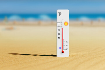 Sea coast at hot summer day. Fahrenheit scale thermometer in the sand shows plus 90 degrees 