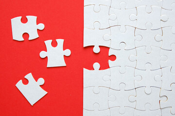 A picture of 3 jigsaw with one empty puzzle need to fit in for problem solving concept on red paper.