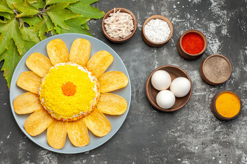 top view of salad with herbs and eggs on the left and leaves on the right on dark background