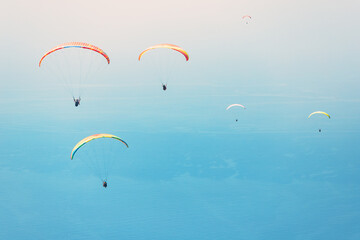 Team of paragliders flying in the blue sky. Takeoff from famous spot on Babadag mountain