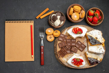 top view cake slices with cookies and chocolate on a dark background biscuits fruit sweet