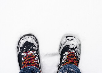 Close-up of  snow-covered boots  durring  winter