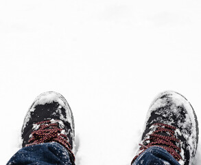 Close-up of  snow-covered boots  durring  winter