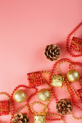 Christmas or new Year pink background with red and gold decorations for Christmas tree with free space.