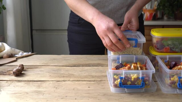 Homemade takeaway food in plastic containers. Woman cooks healthy office lunch portion at home. Healthy calorie controlled meals