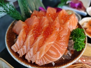 Fresh salmon sashimi (Sake sashimi) topping with ikura (Red caviar).