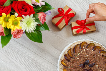 Naklejka na ściany i meble Chocolate cake decorated with plums and flowers