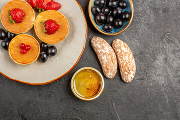 top view yummy pancakes with fruits and cakes on dark floor fruit pie sweet cake