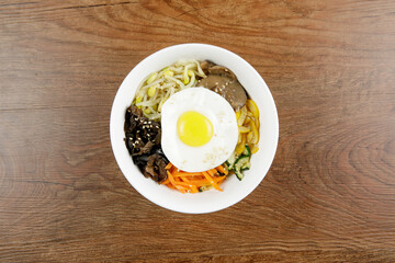 Delicious Korean food Bibimbap serve in white bowl
