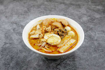 Delicious homemade curry noodles ( mee kari ) serve with seafood and egg