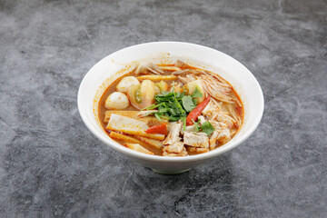 Chicken Tom Yum Noodle serve in white bowl