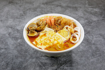 Delicious homemade curry noodles ( mee kari ) serve with seafood and egg
