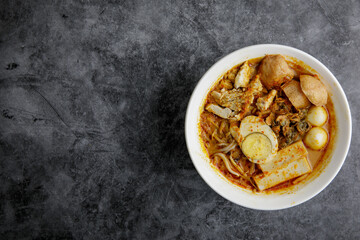 Delicious homemade curry noodles ( mee kari ) serve with seafood and egg