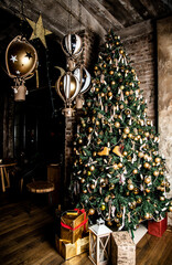 beautiful big Christmas tree decorated with balls and toys holiday christmas mood gifts with ribbons. 