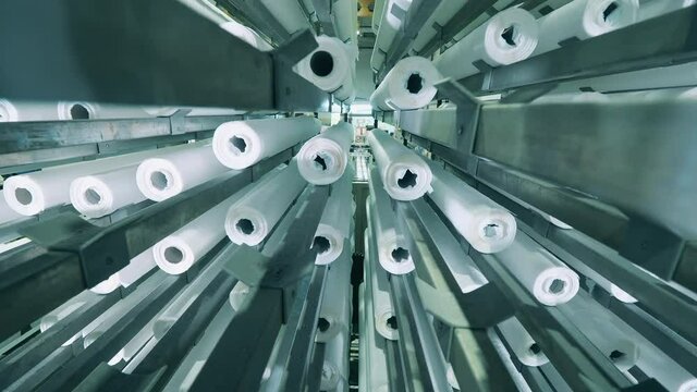Paper rolls inside of a moving factory machine