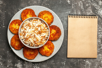 top view fried cutlets with cooked rice on dark background food rissole