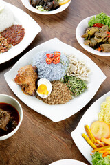 delicious homemade nasi kerabu with salted egg and grill chicken ( ayam percik )