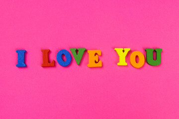 inscription I love you in colored letters on a pink background