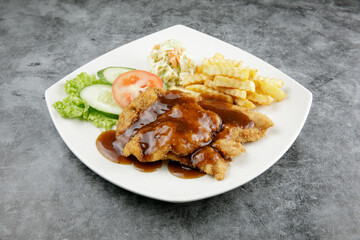 a plate of chicken chop set come with french fries and coleslaw