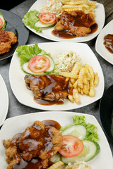 a plate of chicken grill set come with french fries and coleslaw