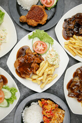 a plate of chicken chop set come with french fries and coleslaw