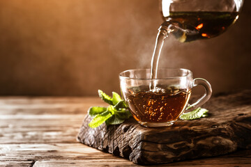 Cup of hot tea with fresh mint leaves - obrazy, fototapety, plakaty