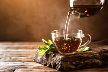 Cup of hot tea with fresh mint leaves