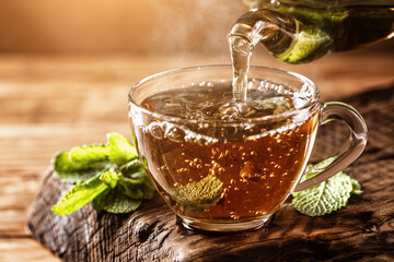 Cup of hot tea with fresh mint leaves