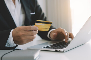 business hands holding credit card and using laptop computer for online shopping, Online payment and shopping