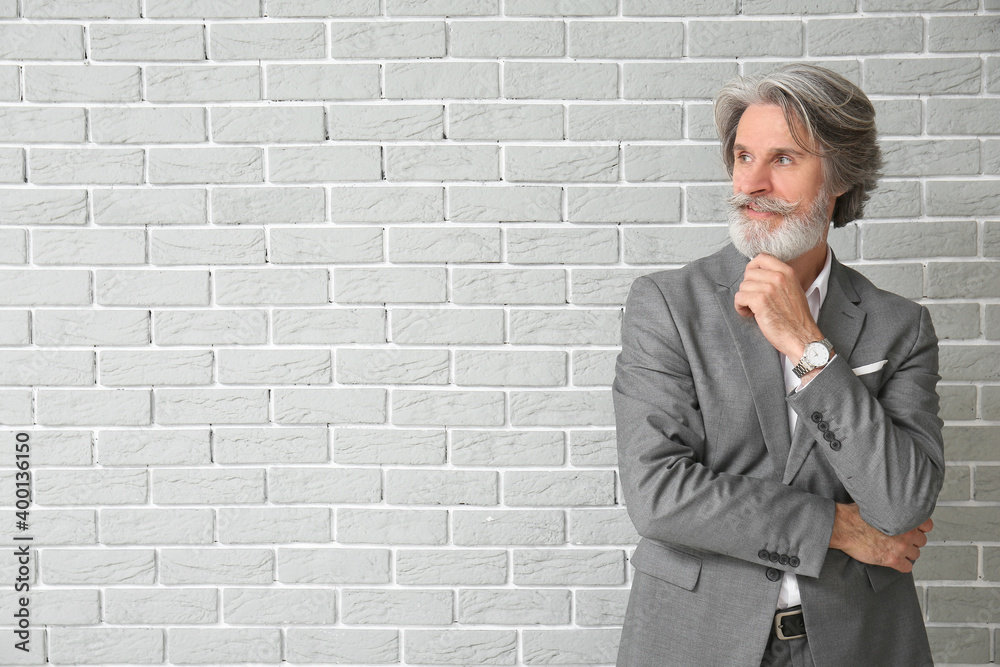 Canvas Prints Mature man in formal suit on brick background