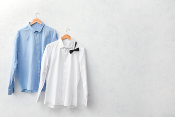 Stylish male shirts on light background