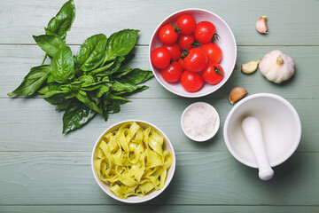 Bowl with tasty pasta and ingredients on color background
