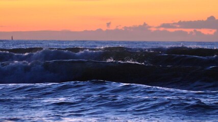Stormy Sea Waves and Breakwater Poles at Baltic Sea after Sunset Slow Motion