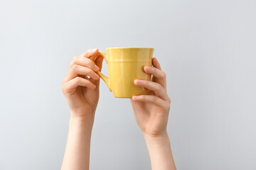 Hands with cup on white background