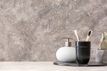 Holder with wooden toothbrushes on table in bathroom