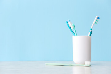 Holder with toothbrushes on table