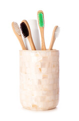 Holder with wooden toothbrushes isolated on white background